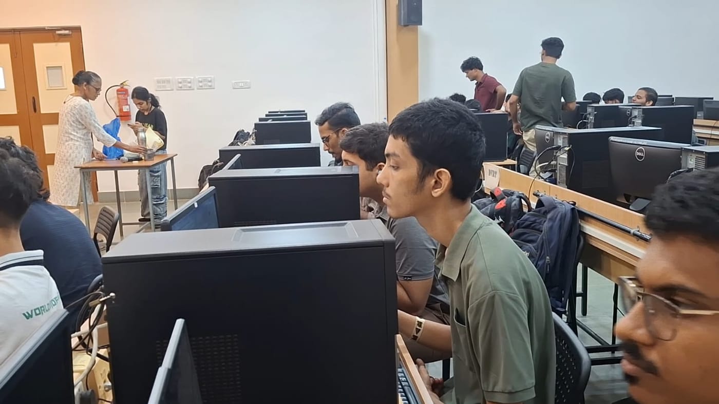 Participants coding at desktop computers in a lab during the PCCE Hackathon 2026